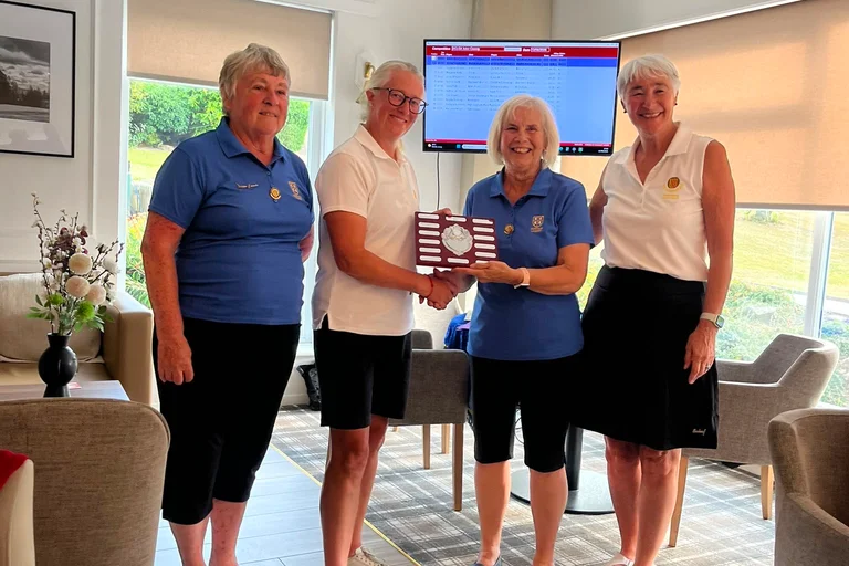 Helen receives the Dunn/Mair trophy for the winning  team, pictured with NLCGA President Viv Younger, Anne Mair, Durham President and Marian Goodyear, Durham Captain