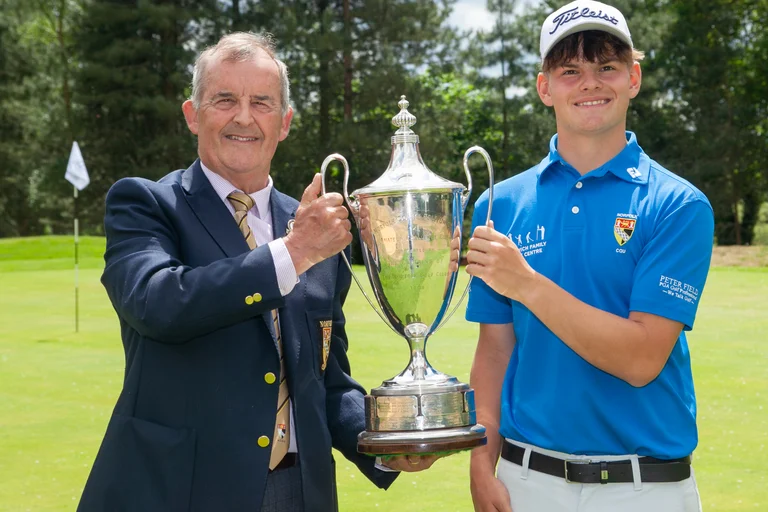 Norfolk County Golf Union president Stuart Goodman hands over the silverware to Norfolk Amateur champion Sully Goddard